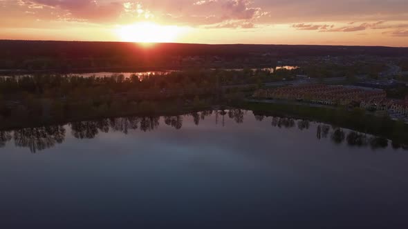 Colorful Sunset Over the Bay the Drone Slowly Flies Back in Front of the Forest and the Road Ukraine