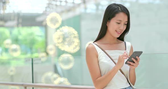 Young woman use of mobile phone in city