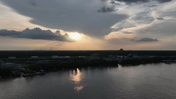 Aerial reverse reveal of sunset over Mississippi River in New Orleans