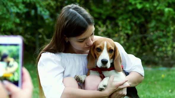 Girl Photography Woman on Mobile Phone Who Hugs and Kisses a Beagle Dog