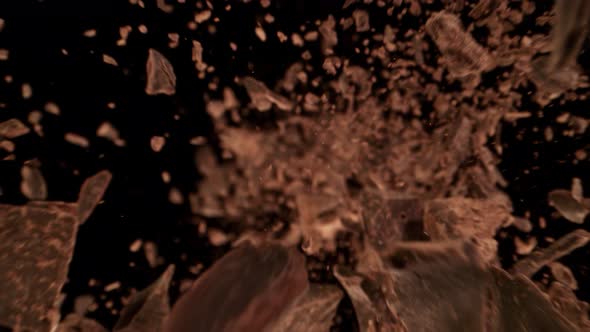 Super Slow Motion Detail Shot of Raw Chocolate Chunks Flying Towards Camera at 1000Fps