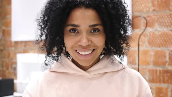 Smiling AfroAmerican Woman Looking at Camera in Office