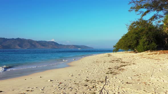 Beautiful birds eye abstract view of a white sand paradise beach and blue sea background in colourfu