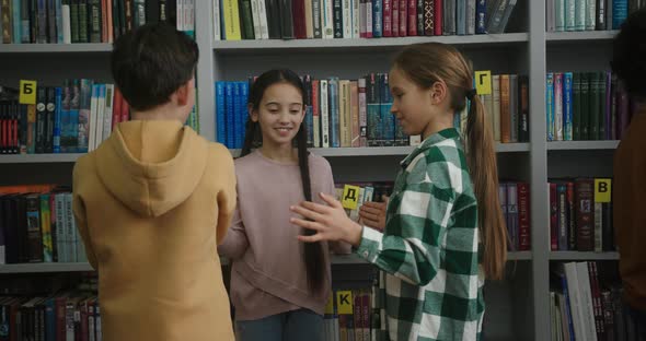 Kids Play Fun Game Near Boys Talking in School Library