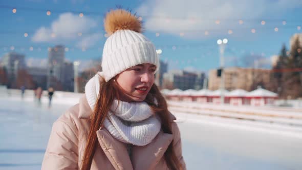 Young Smiling Woman Ice Skating Outside on Ice Rink Central City Square at Christmas Holiday Active