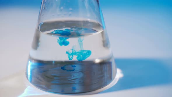 In the Laboratory a Scientist Conducts a Chemical Experiment