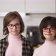 Portrait of Two Happy Girls with Down Syndrome in Eyeglasses - VideoHive Item for Sale