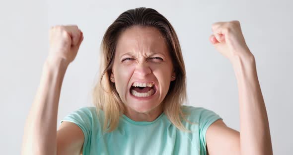 Portrait of Beautiful Young Caucasian Woman Screaming in Anger Directly at Camera