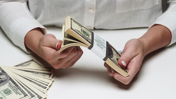 Businessman Flipping Through the Bills in a Bundle of Money Rich Man Holding a Stack of 100 US