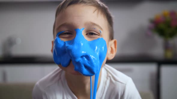 Adorable Funny Boy with Face Covered Blue Slime