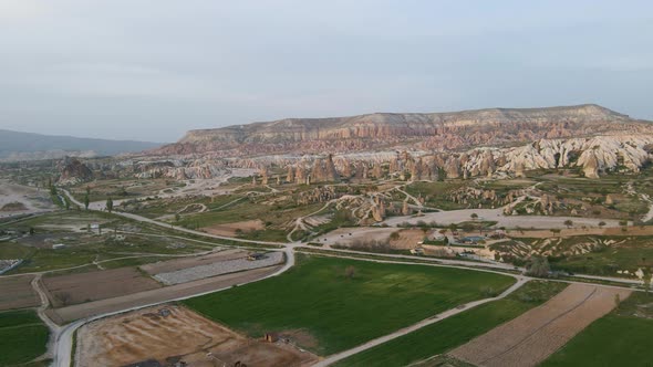 Aerial drone view over roadways through rural coutnryside in Cappadocia, Turkey during evening time.