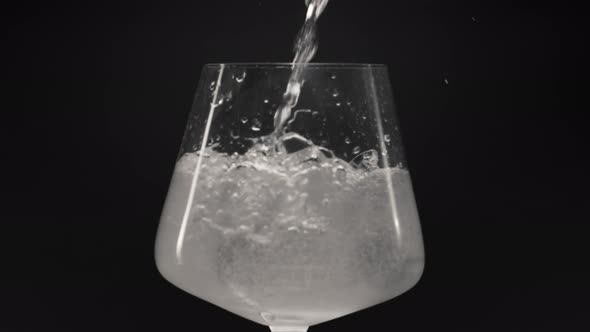 Sparkling Water Pouring Ice Glass Closeup Slow Motion