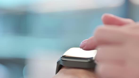 Close up of Female Hands using Smartwatch