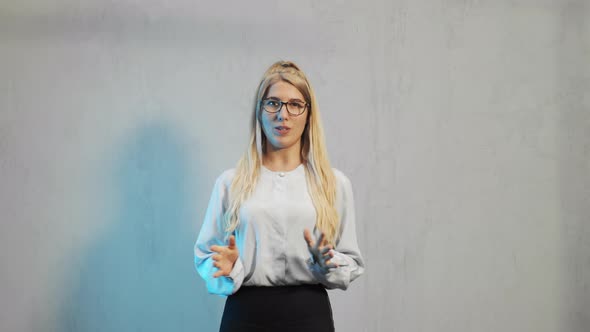 Young Woman Talking To Camera Smiling Presenting Teaching To Colleagues