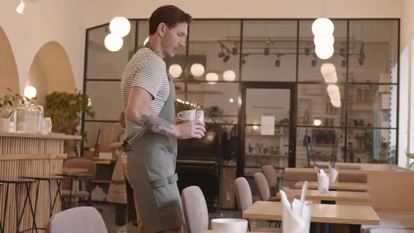 Waiters Setting Tables with Tableware