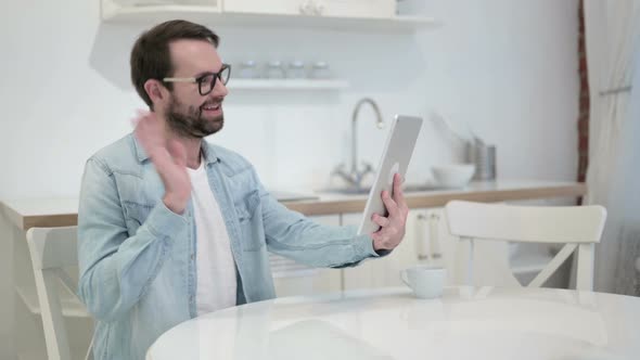 Beard Young Man Doing Video Chat on Tablet in Office