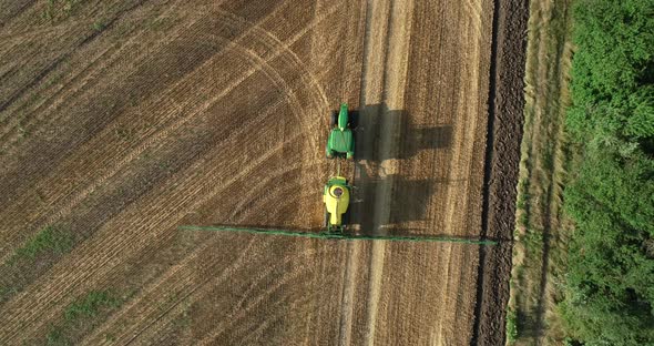 Top down view of farming tractor spraying on field. Protection of plants.