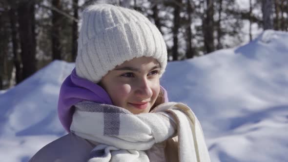 Little Girl Playing with Snow Outdoors in Winter