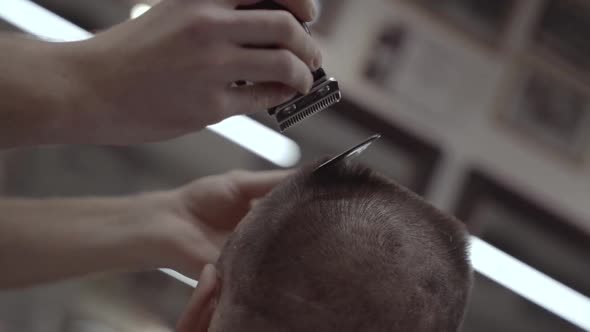 Haircut Electric Shaver. Men's Haircut in a Barbershop. 