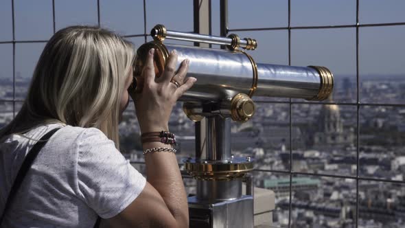 Woman Observing City with Coin Binocular