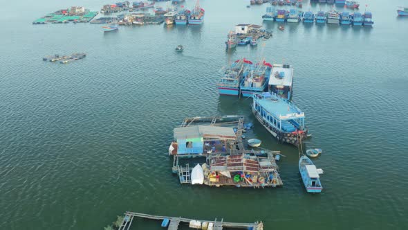 Drone view of Hon Ro pier, on Nha Trang river, with many fishing boats are nailing side by side. Nha