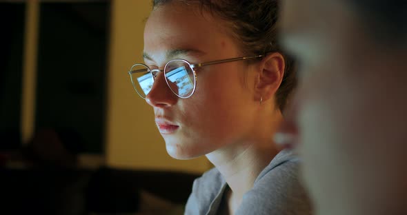 Reflection in Glasses of Woman Working on Computer