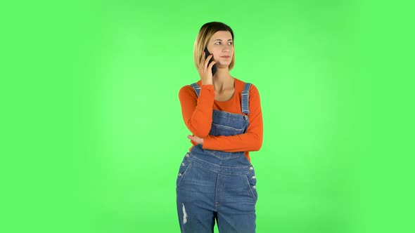 Woman Speaking Via Telephone Looking Boredon. Green Screen