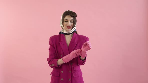 A Stylish Pinup Woman with Bright Makeup and Rubber Gloves Starts Cleaning