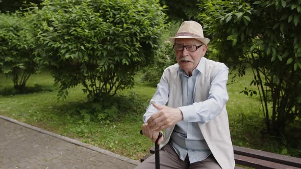 An Old Man Sitting in the Park and Meet His Son