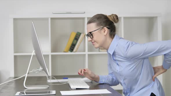 Young Casual Girl with Spinal Back Pain Working on Computer