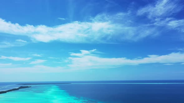 Wide angle overhead abstract view of a white sand paradise beach and aqua blue ocean background in b