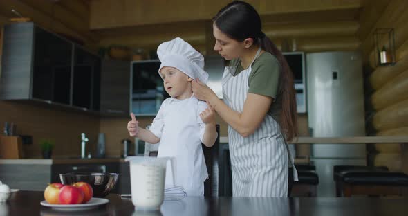 Mom Dresses Her Son in Chef's Uniform to Start Cooking Together
