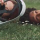A young couple lying on the grass trying on vr goggles - VideoHive Item for Sale