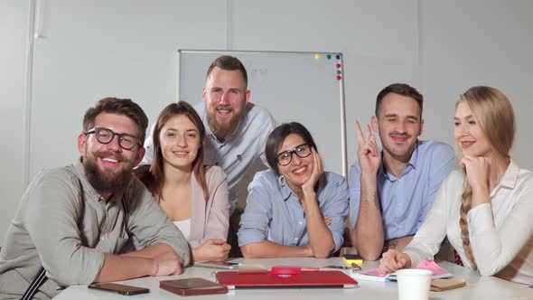 Happy Working Collective of Company Is Smiling and Looking at Camera