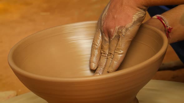 Potter at Work Makes Ceramic Dishes