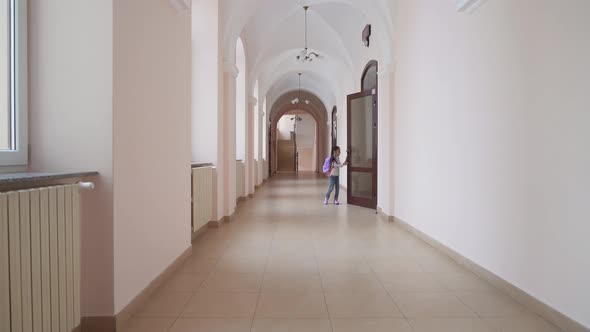 Girl with Backpack Coming Out of Classroom.