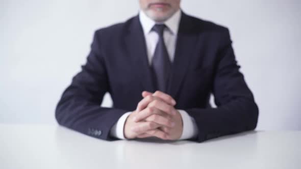 Respectable Businessman Sitting at Office Table Ready to Discuss Cooperation