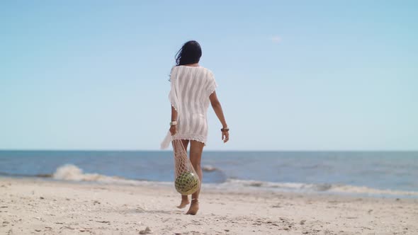 Romantic Woman with Watermelon on the Beach Outdoors