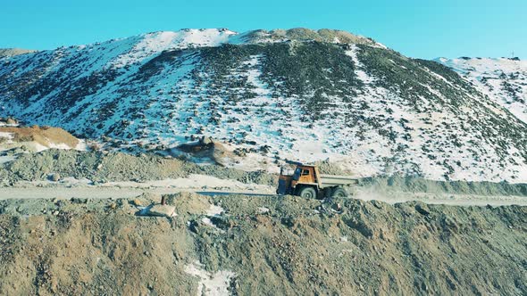 Snowy Copper Mine with a Truck Riding Along It