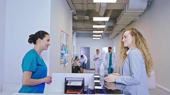 Beautiful Nurse at the Reception Meet the Patient