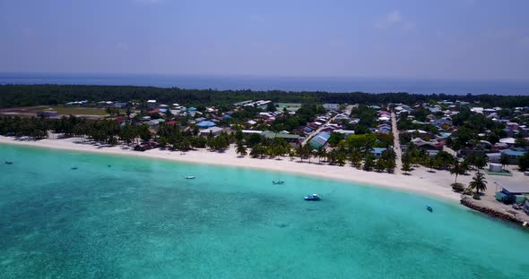 Wide fly over island view of a paradise sunny white sand beach and aqua turquoise water background i