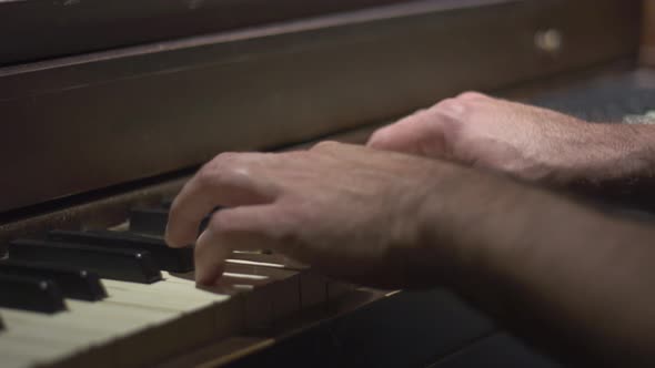 Close-up of Man's Hands Playing the Piano