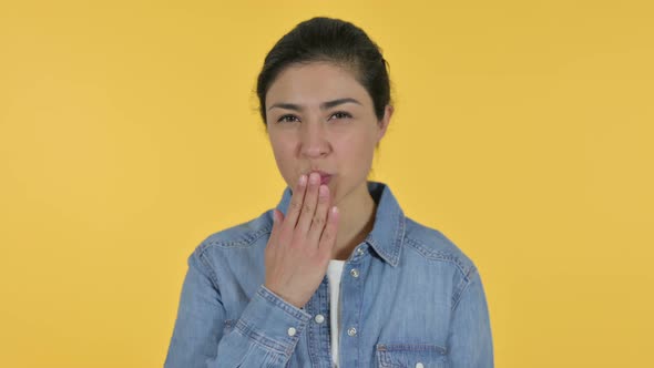 Indian Woman Giving Flying Kiss, Yellow Background 