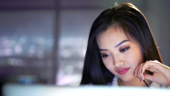 Closeup Portrait of Attractive Asian Young Businesswoman Working Late Night in Office