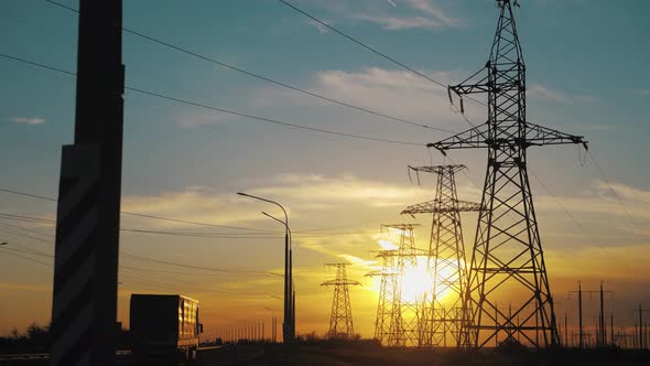 Silhouette of Electric Tower Over Sunset Time. Electricity Pylon Against Sky.