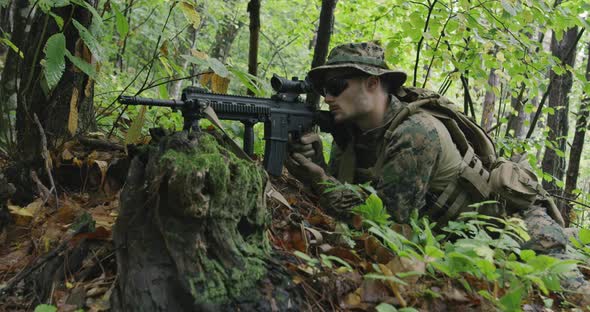 Fully Equipped Rifle Soldier Wearing Camouflage Uniform Attacking Enemy Rifle in Firing Position in