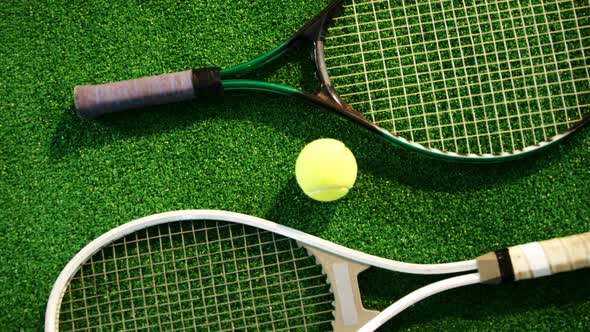 Tennis ball and rackets arranged on grass 4k