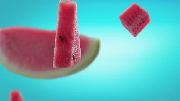 Flying of Watermelon and Slices in Ice Blue Background