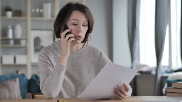 Old Woman Discussing Documents During Phone Talk Contract