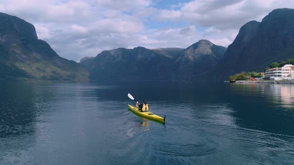 Aerial Drone Shot of Yellow Kayak in Fjord Water